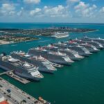 Aerial view of Port Canaveral packed with five mega cruise ships including Royal Caribbean’s Icon of the Seas and Disney Wish, celebrating 8.6 million passengers in 2025
