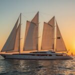 The iconic 88-meter superyacht Maltese Falcon sailing at sunset with its revolutionary DynaRig sails fully deployed, now part of Jumeirah Privé luxury yacht collection in December 2025