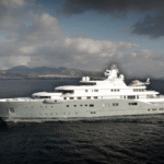 110m Lürssen superyacht Radiant cruising through the waters of Athens with mountains and cityscape in the background