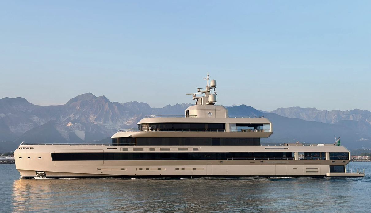 The 72-metre Admiral superyacht No Rush cruising in calm waters with mountains visible in the background